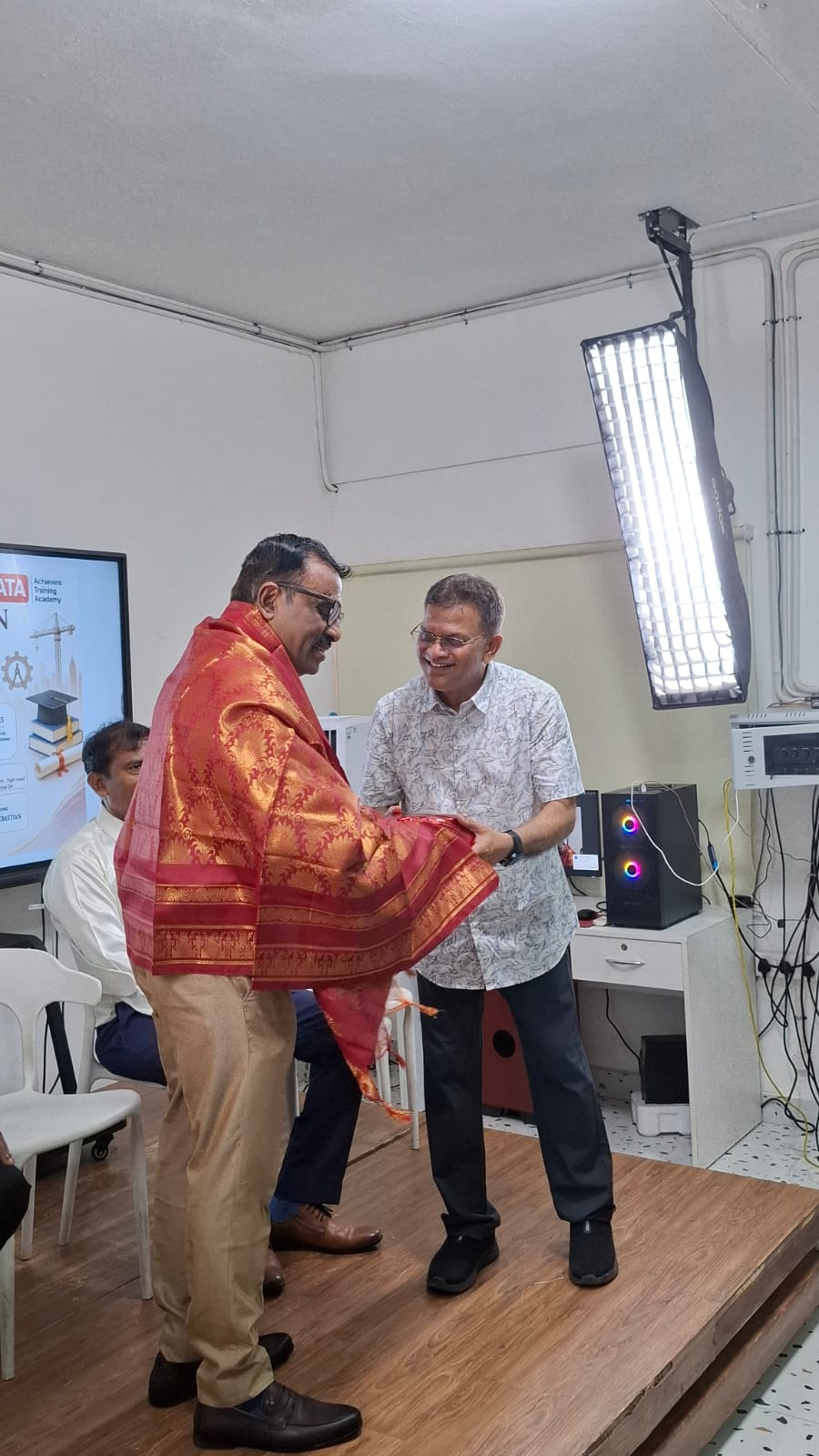 Traditional shawl presentation to a guest at the NEET and JEE program launch