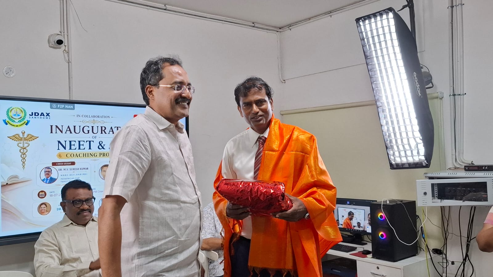 Guest being honoured with a shawl and memento at the coaching program inauguration